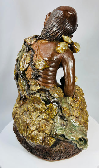 Antique Chinese ceramic statue of Jigong with expressive face and earthy glaze tones.