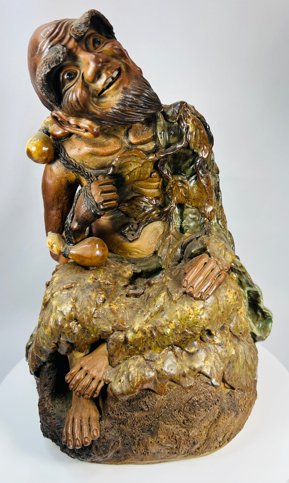 Chinese terracotta sculpture of Jigong with humorous expression and green amber glaze.