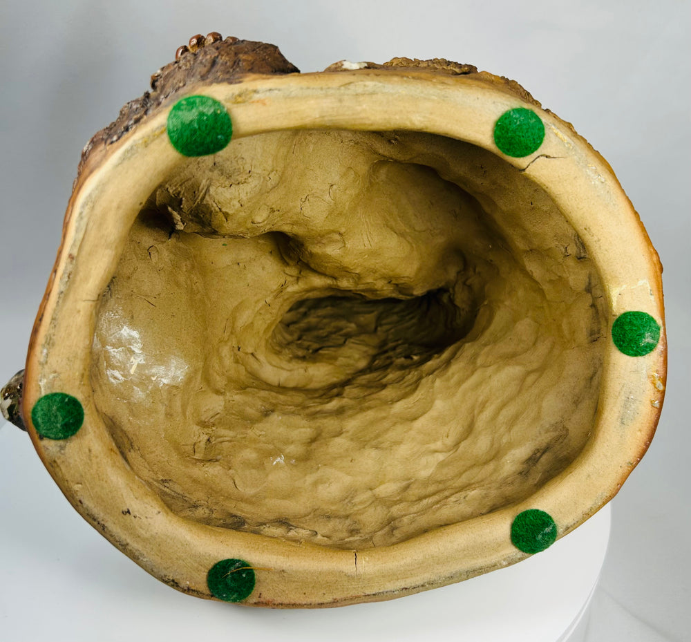 Antique Chinese Buddhist folk figure of Jigong seated with gourds and vine leaves.