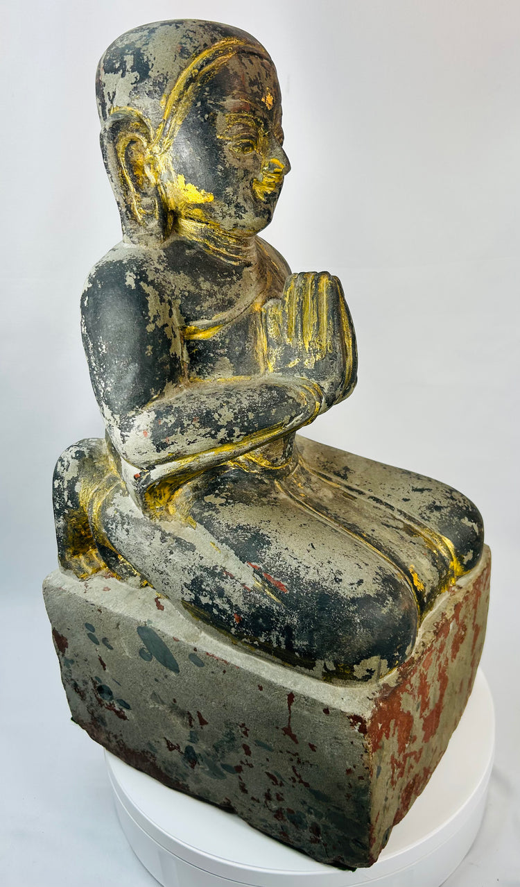 Antique Burmese temple figure of a kneeling devotee in añjali mudrā with worn parcel gilding.