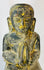 Historic Burmese Buddhist temple sculpture of a kneeling devotee with aged gilding.