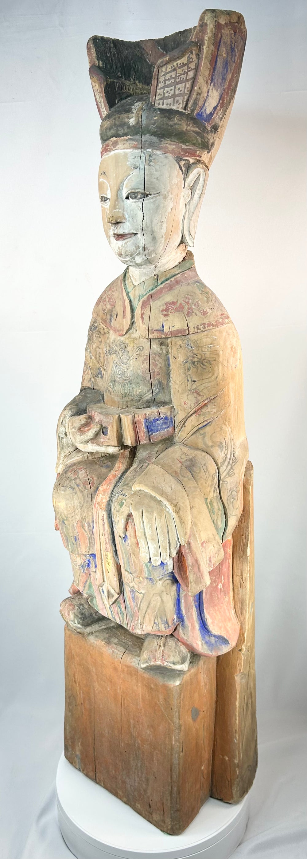 Qing dynasty Chinese carved wood statue of a seated court official with colorful polychrome.