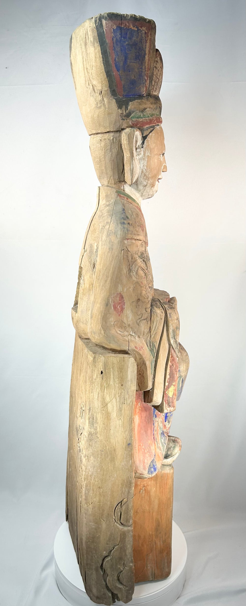 Historic Chinese polychrome wood statue of a seated court official with tall headdress.