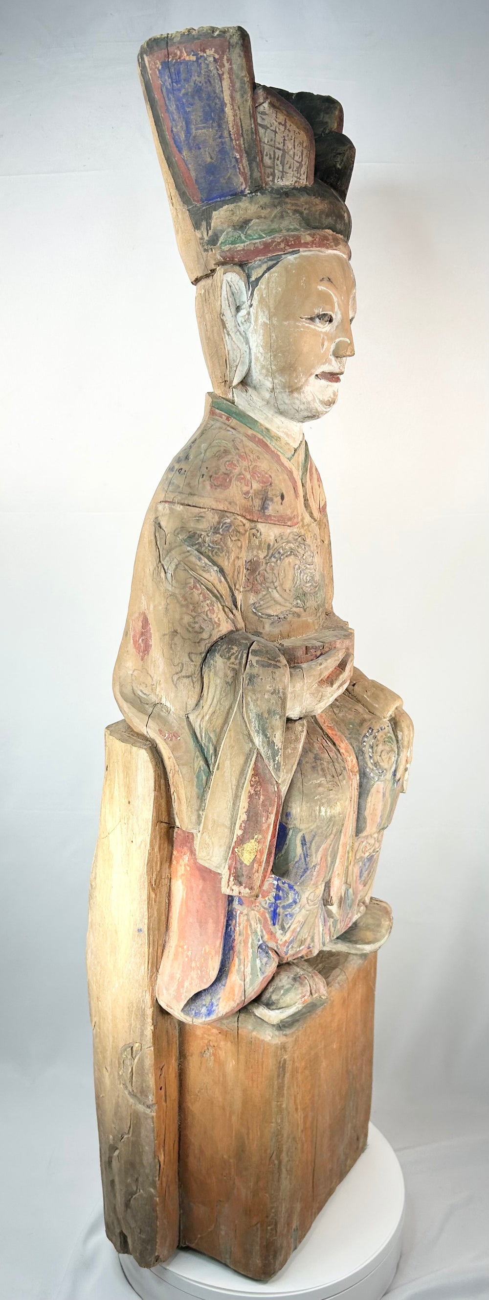 Antique Chinese carved wooden official figure with elaborate painted robes and tablet.