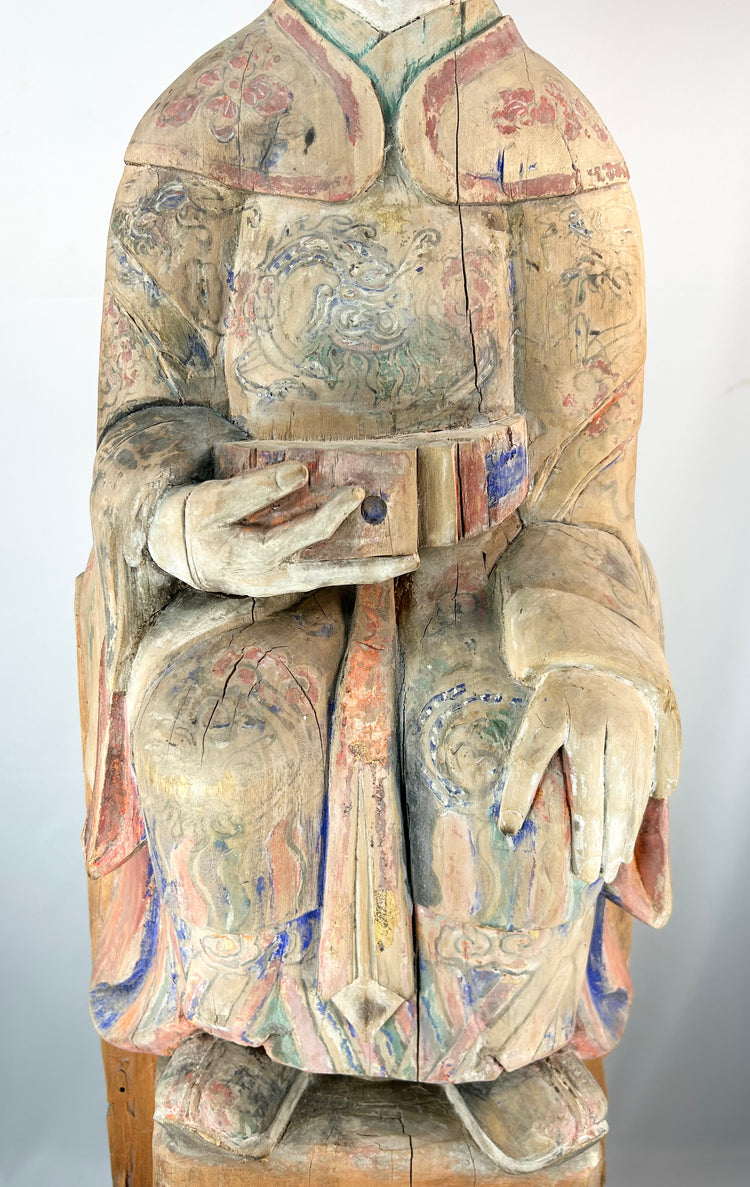 Chinese shrine sculpture of a seated court official with colorful painted decoration.