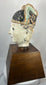 Chinese temple bust of a scholar-official with black ceremonial hat and red lips.