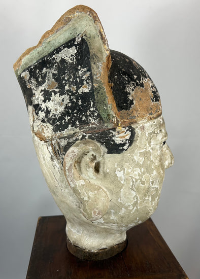 Chinese temple sculpture bust with black lacquer hat and pale mineral slip face.
