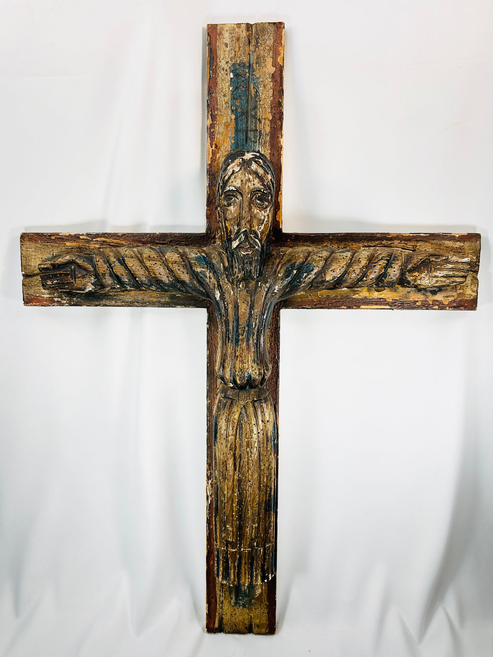 Antique Spanish Colonial folk crucifix with expressive carved Christ figure.