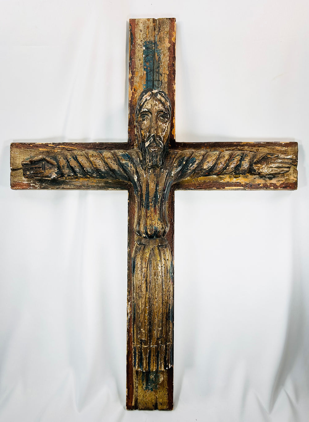 Hand-carved wooden crucifix of Christ in Spanish Colonial devotional style.