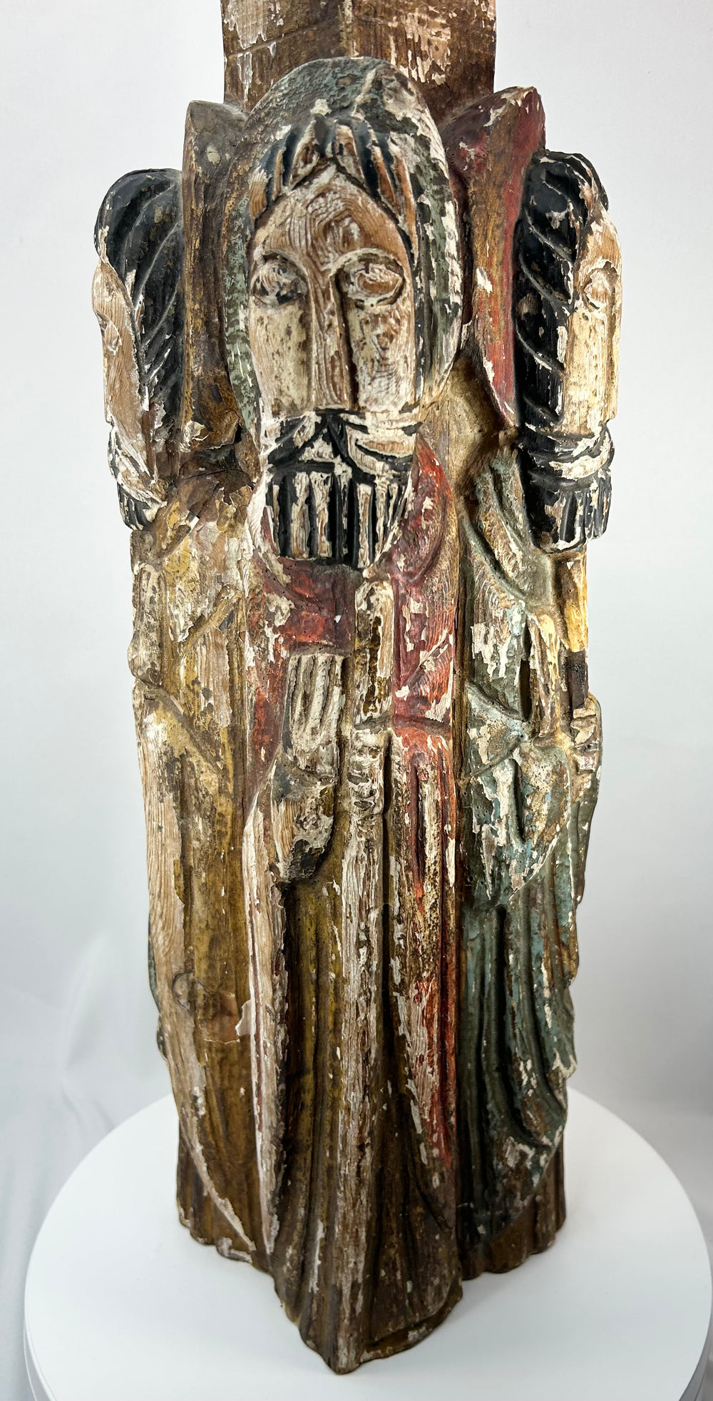 Spanish Colonial religious wood carving with four haloed saints in arched niches.