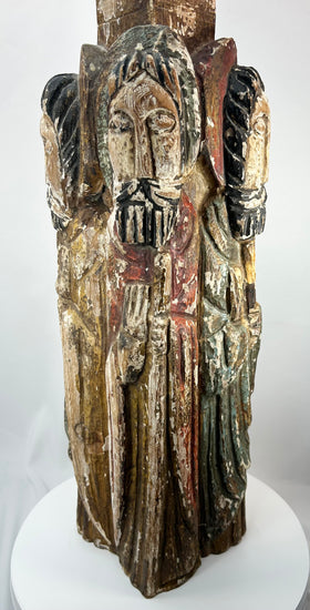 Spanish Colonial religious wood carving with four haloed saints in arched niches.