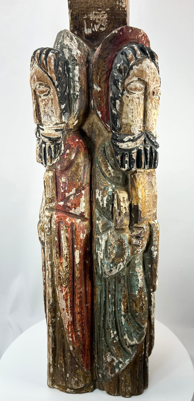 Antique ecclesiastical column sculpture with four carved saints and remnants of paint.