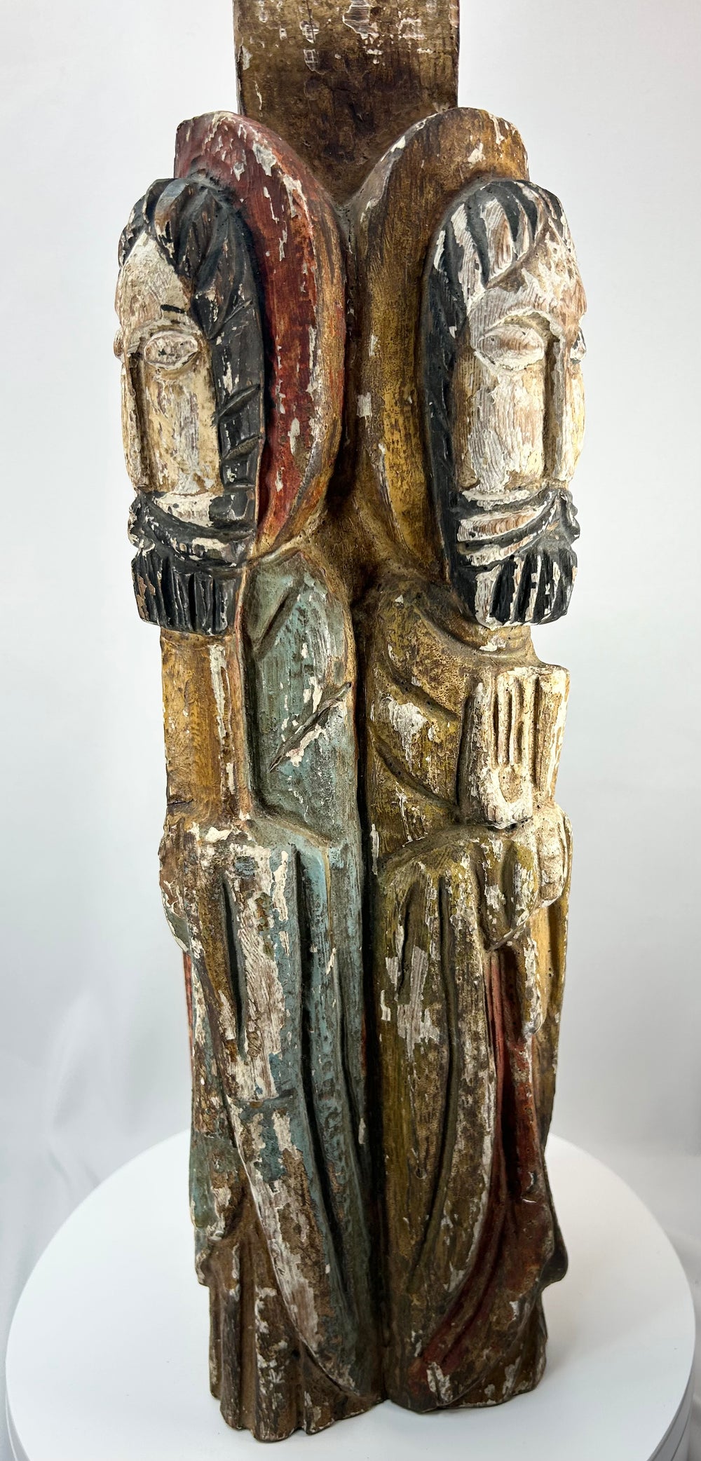 Spanish Colonial carved wood devotional column with saint figures and aged patina.