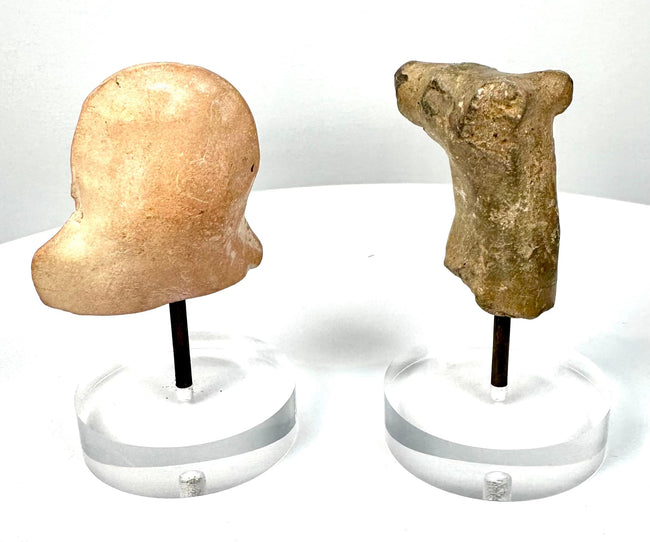 Ancient Mesopotamian terracotta animal head with projecting ears, prominent muzzle, and weathered grey-brown ceramic surface.