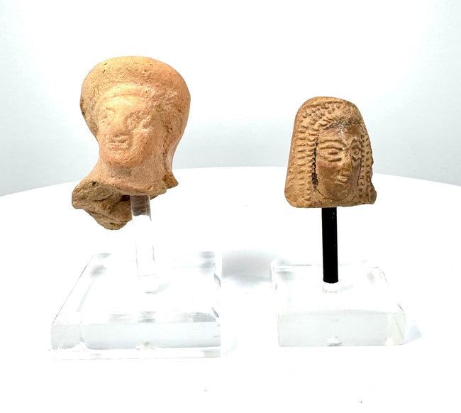 Ancient Etruscan female votive head and East Greek terracotta protome featuring distinctive hairstyles and weathered earthenware surfaces.