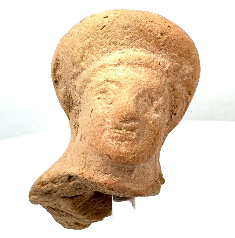 Ancient Etruscan female head fragment displaying a smooth elevated coiffure, elongated nose, delicate facial features, and natural surface wear.