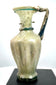 Eastern Mediterranean glass jug featuring decorative blue-green trailing beneath the mouth and a raised glass band encircling the lower neck.