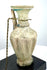 Ancient Roman pale green glass vessel featuring pronounced vertical ribbing, a slender cylindrical neck, and applied blue-green decorative trails.