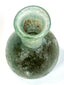 Early Roman sea-green glass unguentarium displaying a spherical body, thickened flaring rim, and weathered glass surface with iridescent deposits.