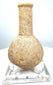 Roman Imperial stone perfume vessel with a spherical body, narrow neck, and weathered buff-coloured surface, catalogued as volcanic tuff.