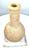 Ancient Roman carved stone unguentarium displaying a thick outward-flaring rim, circular mouth, and distinctive porous stone construction.
