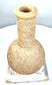 Ancient Roman carved stone unguentarium displaying a thick outward-flaring rim, circular mouth, and distinctive porous stone construction.