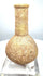 Roman stone perfume bottle featuring a rounded lower chamber, recessed neck band, and natural beige to sandy-brown coloration.