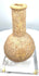 Roman-period carved stone vessel exhibiting extensive mineral deposits, surface abrasions, and natural irregularities across its bulbous body.