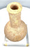 Ancient Roman Imperial unguentarium with a long cylindrical neck, pronounced rounded shoulders, and coarse granular stone texture.