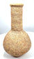 Roman stone unguentarium attributed to the 1st–3rd century CE, featuring a globular body, cylindrical neck, thick rim, and archaeological surface deposits.
