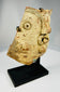 Archaeological terracotta fragment of a Greco-Roman theatrical mask mounted on modern display stand.
