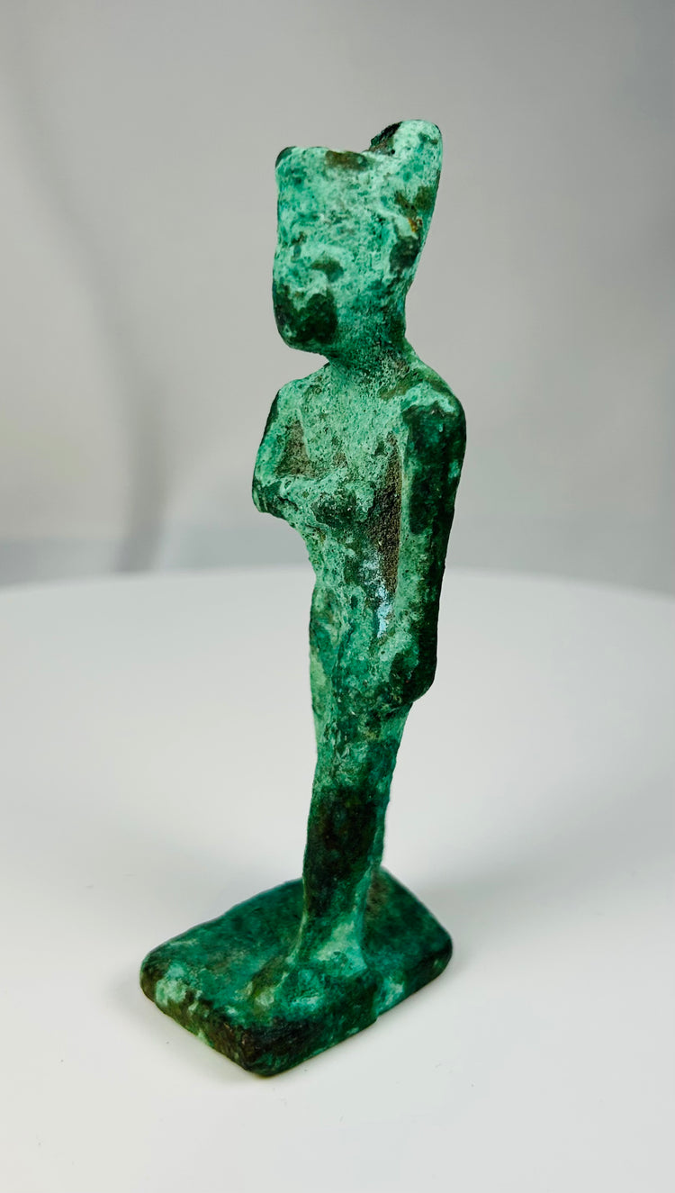 Ancient Egyptian bronze figure of a goddess in traditional frontal pose from the Late Period.