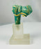 Ancient Egyptian Bastet cat figure vessel handle fragment in turquoise faience glaze.