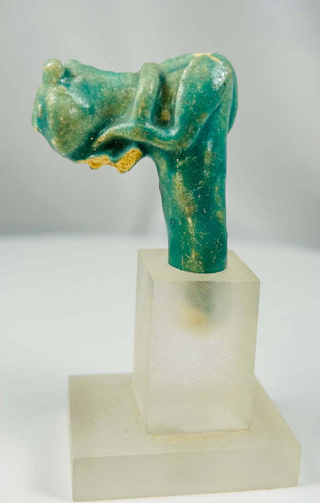 Egyptian faience artifact fragment showing feline head from ritual vessel handle.
