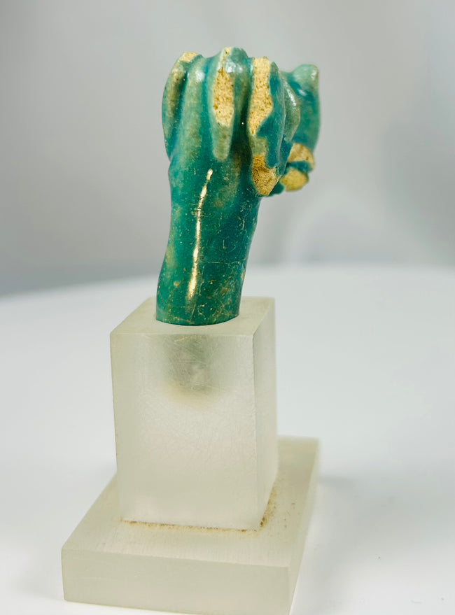 Archaeological fragment of Egyptian faience vessel handle with Bastet feline head.
