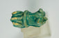 Ancient Egyptian Bastet-themed faience handle fragment with turquoise glaze.