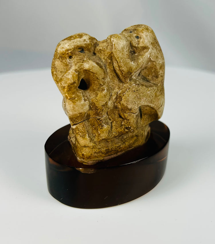 Archaeological limestone sculpture of a sacred baboon from ancient Egyptian religious art.