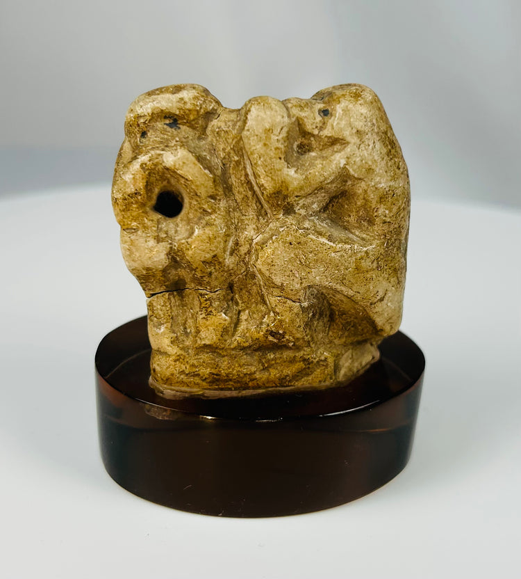 Ancient Egyptian limestone baboon fragment representing Thoth in stylized form.