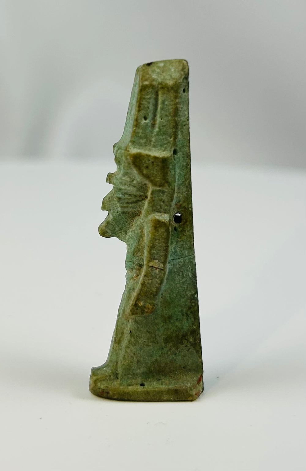 Small Egyptian faience figure of the god Nefertem associated with rebirth and the lotus.