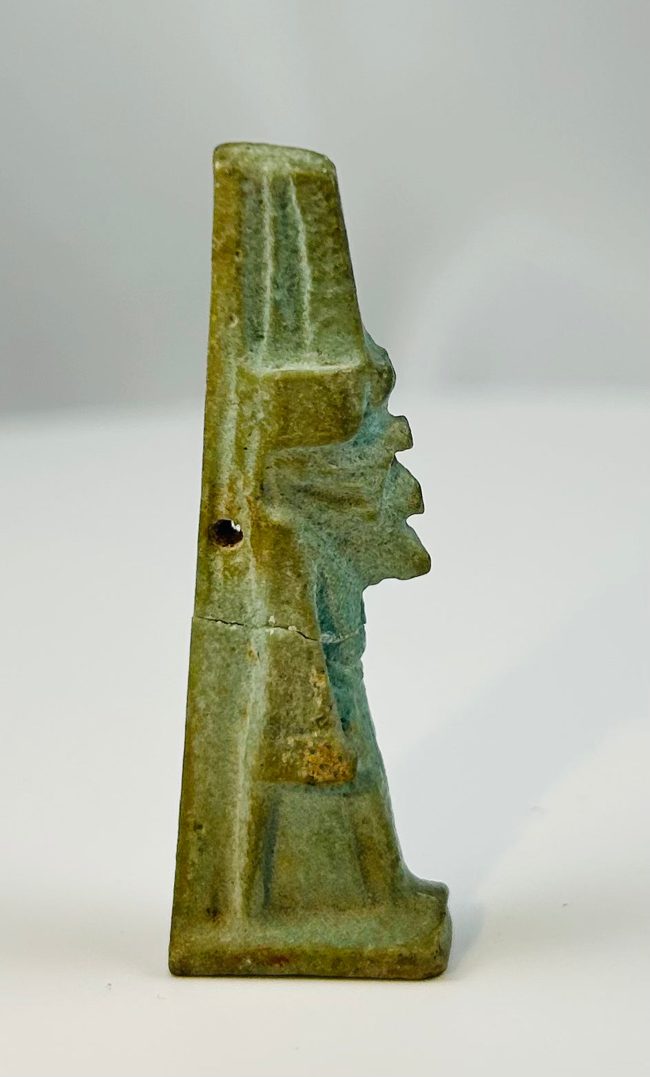 Egyptian Late Period faience amulet showing the god Nefertem in traditional striding stance.