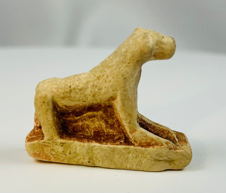 Small Egyptian limestone sculpture of a reclining lioness associated with Sekhmet.