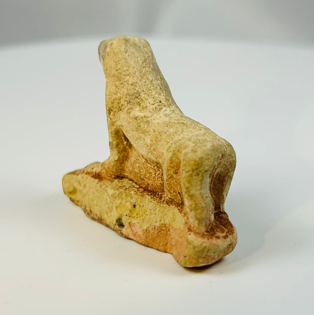 Ancient Egyptian reclining lioness votive sculpture with stylized features.