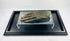 Authentic ancient Egyptian mummified hand (700–200 BCE) displayed on a clear glass stand within a black museum case on a white background — verified artifact from Relic and Rarity.
