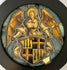 Decorative emblem with an angel and coat of arms on a dark background