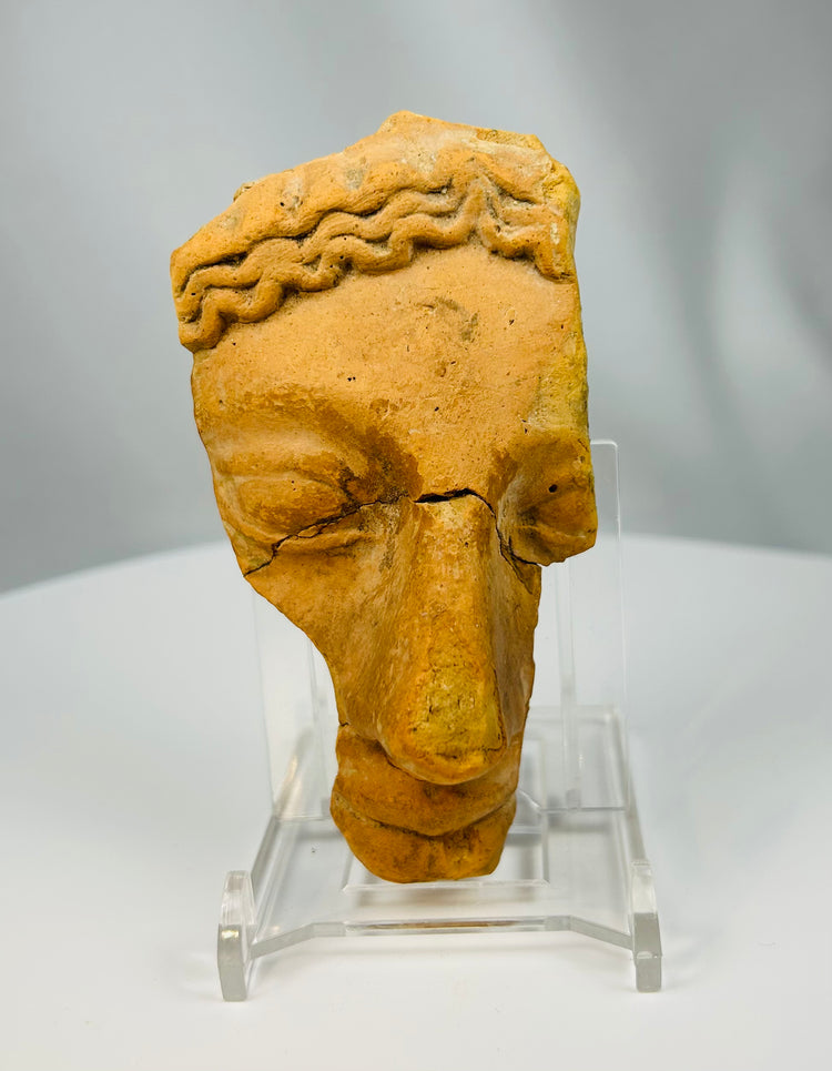 Ancient Mediterranean terracotta dramatic mask fragment with expressive facial modeling