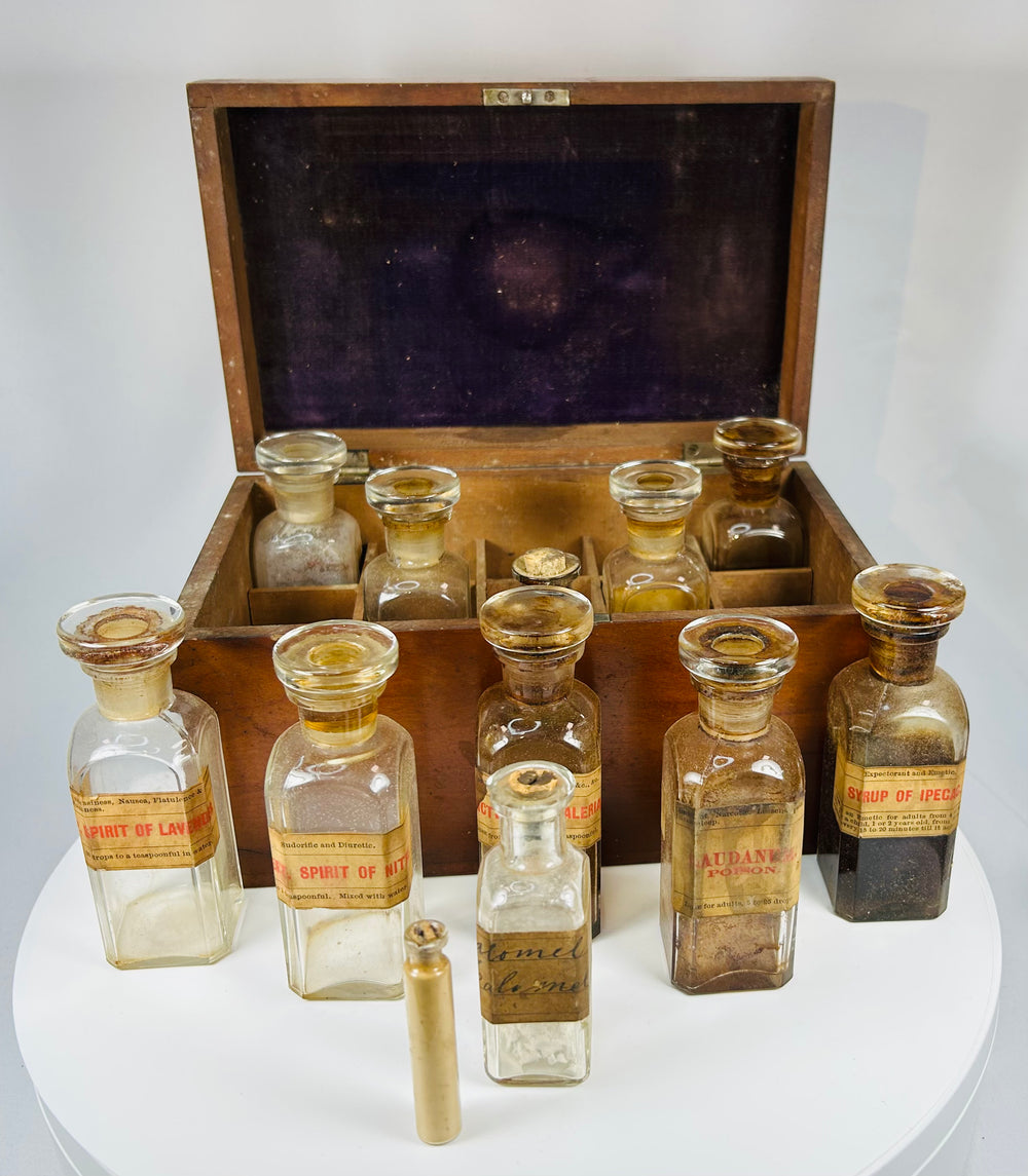 antique Victorian apothecary medicine box with labeled glass pharmacy bottles