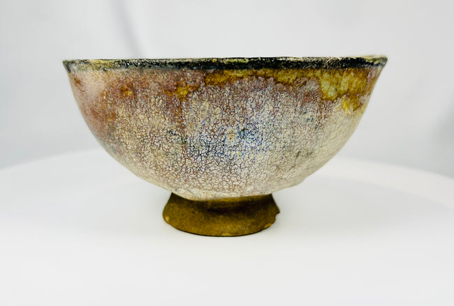 Archaeological Islamic glazed bowl with figural medallion and aged patina