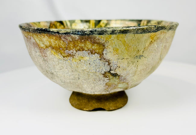 Medieval Middle Eastern ceramic bowl with olive green glaze and painted figure