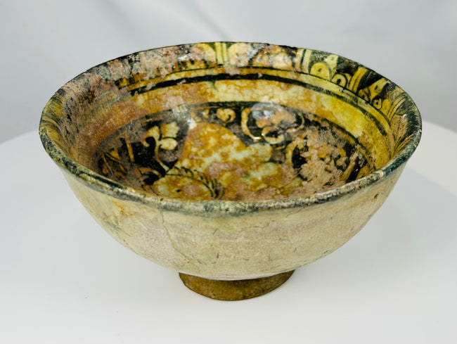 Seljuk period Islamic earthenware bowl with green glaze and black painted decoration