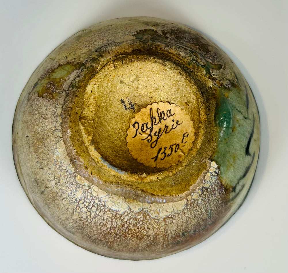 Raqqa ware glazed bowl with stylized figure and vegetal ornamentation